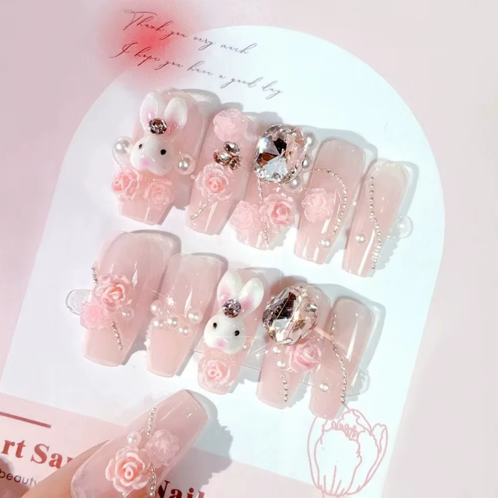 Faux ongles rose poudré avec nœud